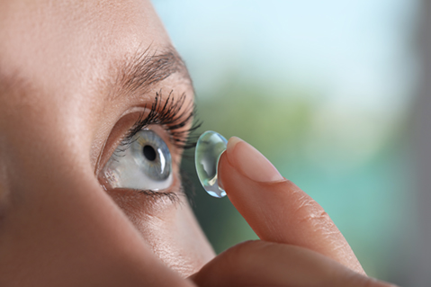 Woman putting in contact lens